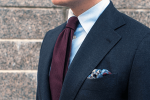 man wearing a darkened blue suit ready to make a good Impression at his new job