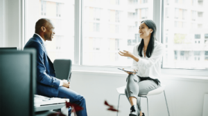 man and woman discussing work related things on the new job