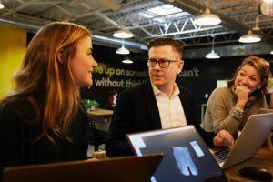 a guy and two girls who are working as recruiters on LinkedIn discuss among each other about their job