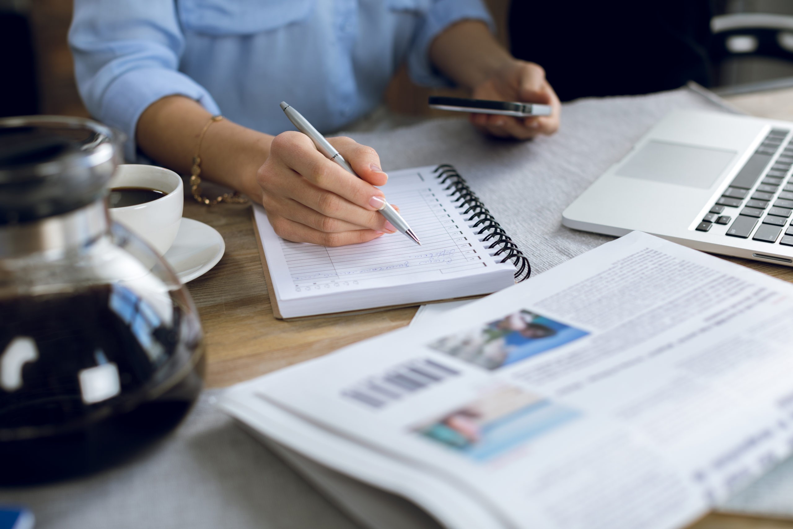 woman taking notes on SWOT analysis for her career