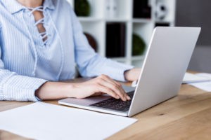 woman working on her computer for her SWOT analysis